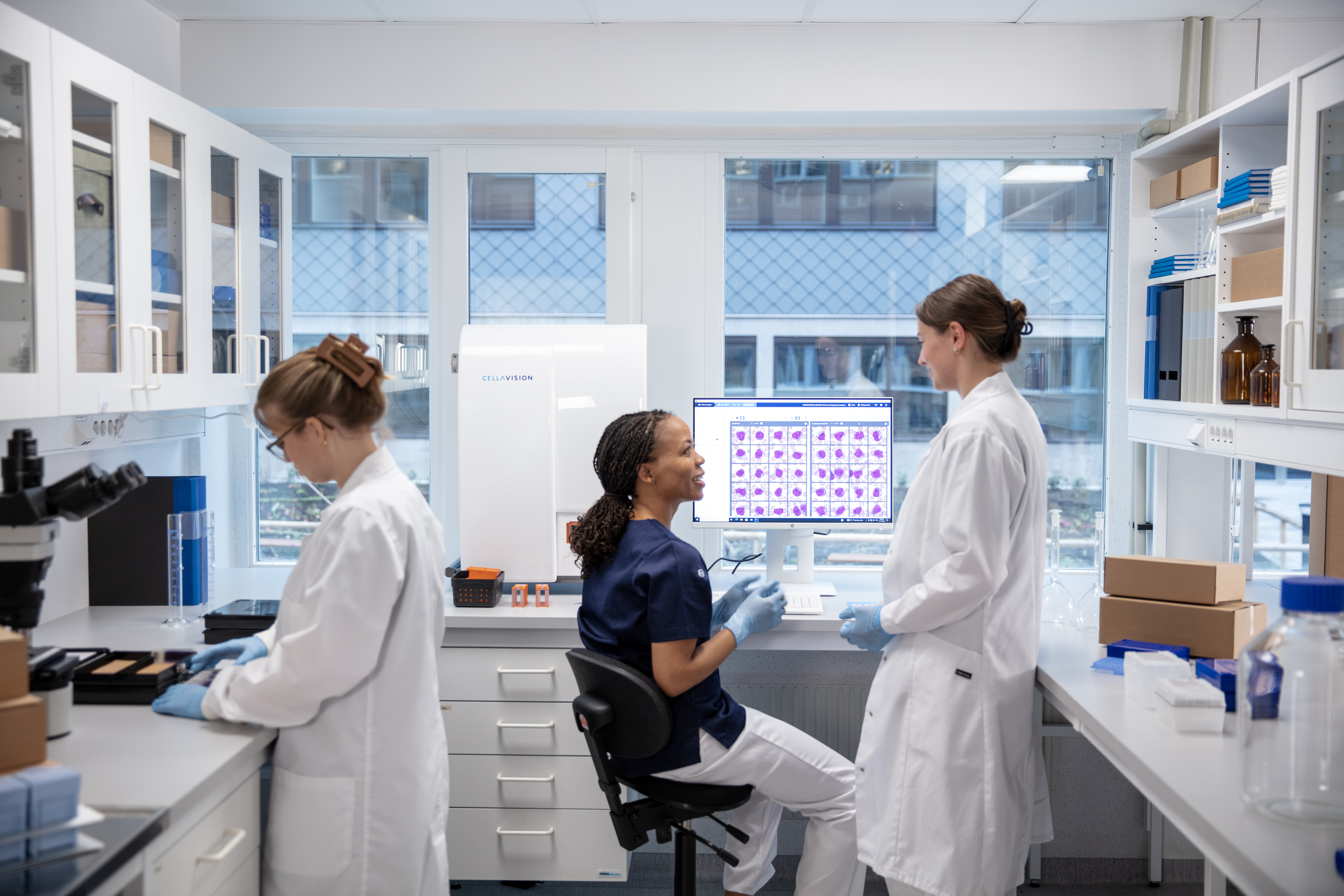 women in lab discussing Digital Cell Morphology
